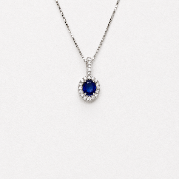 Oval cut Sapphire with a halo in a pendant 