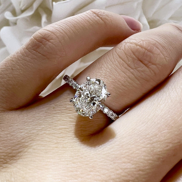 Diamond ring on a finger with a soft white background