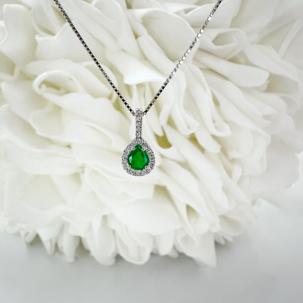Pear shaped emerald in a pendant with a halo 