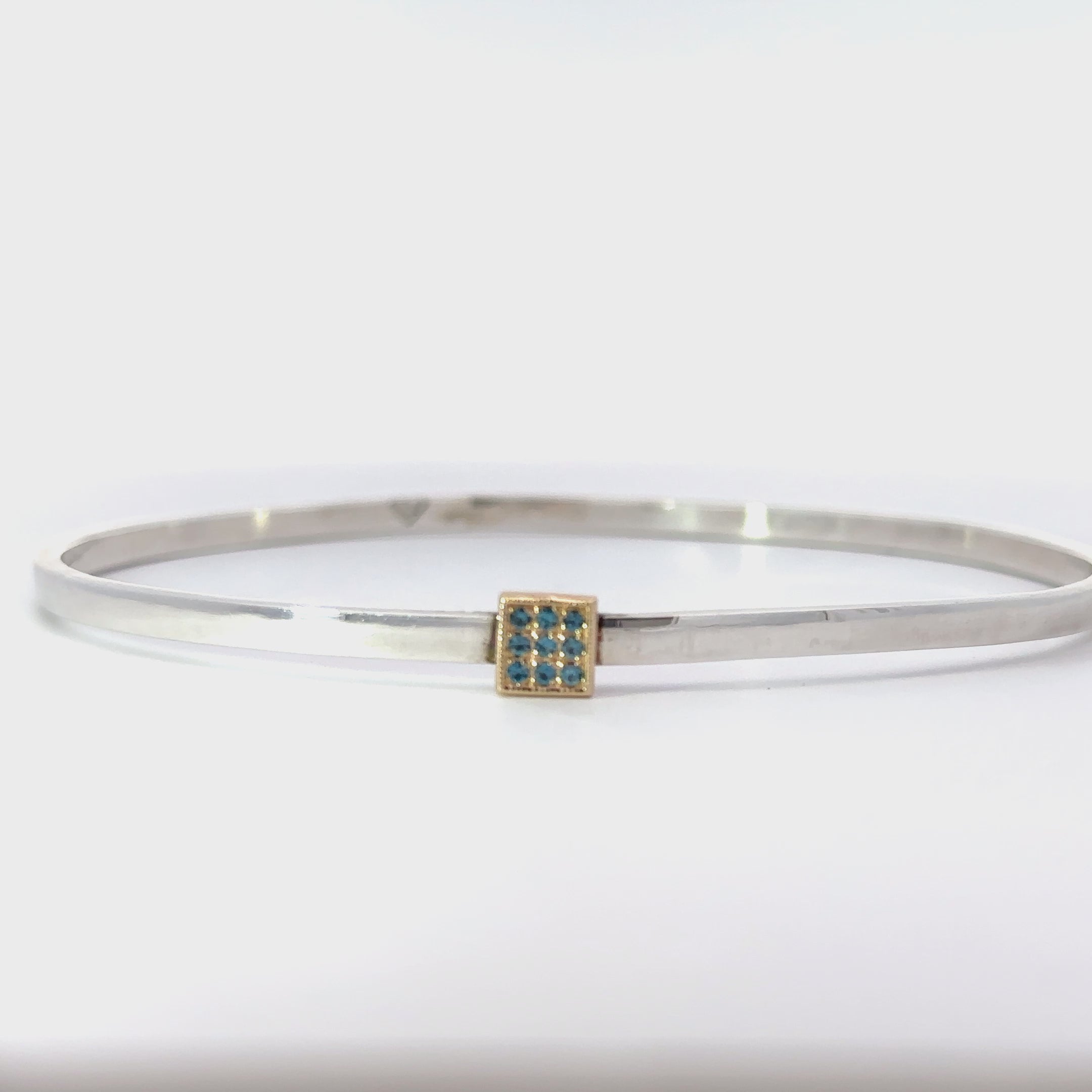 Custom sterling bangle with london blue topaz accent